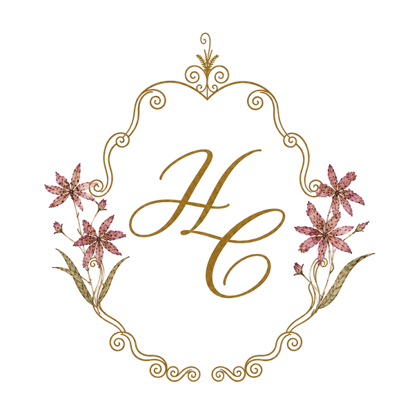 A decorative monogram design featuring the initials 'H' and 'C' in gold script, framed by pink watercolor flowers and gold ornamental flourishes on a warm cream textured background.