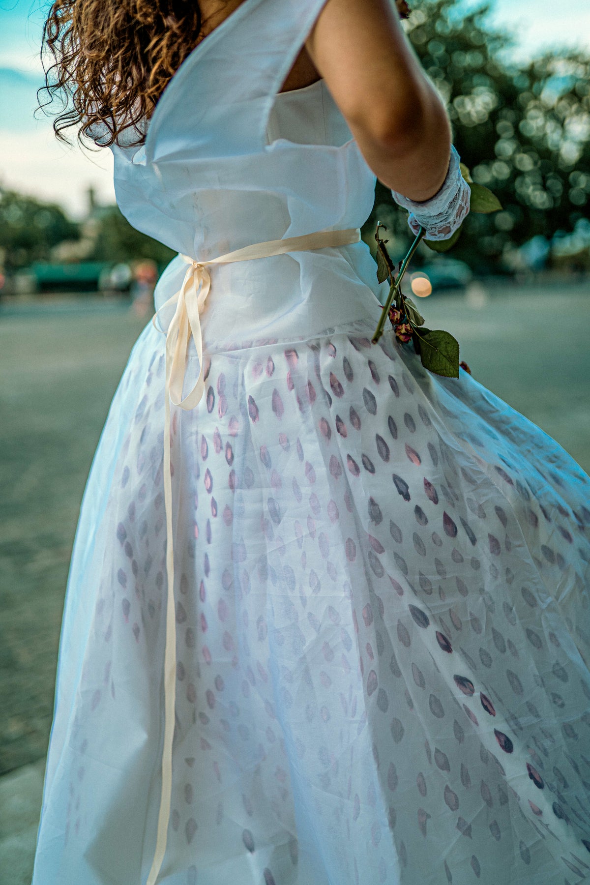The Venus Dress — close-up of hand-painted petal detailing and dried rose accents